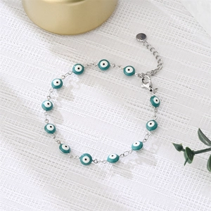 Detailed shot of teal enamel evil eye bracelet with lobster clasp and extension chain