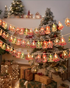 Detail of Christmas LED string lights with warm glowing Santa, tree and bell shapes