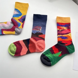 Detailed view of three cotton crew socks with vibrant abstract art and wavy jacquard patterns