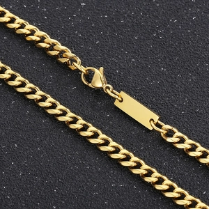 Detailed view of golden Cuban link chain with a lobster clasp and engravable blank tag