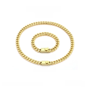 Detail view of gold stainless steel Miami Cuban link chain necklace and bracelet set