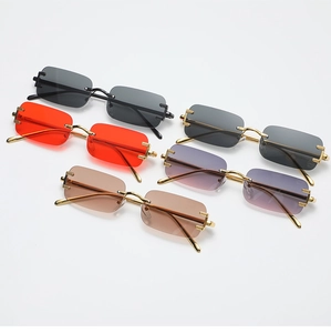Detail view of rectangular rimless sunglasses in multiple lens colors and gold metal frames