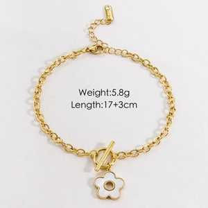 Detail of gold stainless steel toggle clasp bracelet with white flower charm and tag