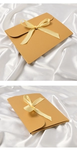 Detailed views of brown kraft paper envelope gift box with elegant yellow ribbon bow detail