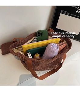 Interior view showing large capacity storage for laptop and umbrella in woven tote bag
