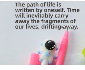 Detailed view of pink astronaut gel pen writing smooth handwriting on white paper