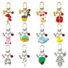 Detailed grid view of twelve assorted colorful enamel keychains with small wish tags