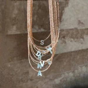Handmade shell beaded necklaces with peach beads and white initial letter pendants charm