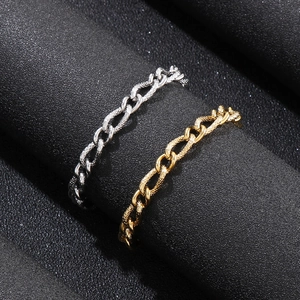 Detailed macro view of gold and silver snake pattern chain rings for men in titanium steel