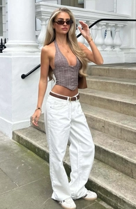 Street style view of brown plaid halter top with white wide-leg jeans and brown leather belt