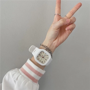 On-wrist view of a white square sports watch with silicone strap and numeric dial display