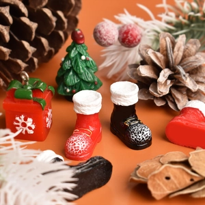 Detail of festive miniature resin Christmas boots, trees and gift boxes for DIY crafts