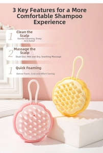 Detailed view of pink and yellow silicone scalp massagers with soft bristles and hanging cords