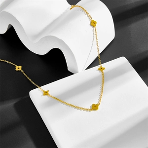 Detail of gold star and heart necklace on geometric block with artistic shadows