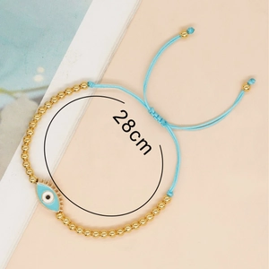 Handmade evil eye beaded bracelet with 4mm gold beads and light blue woven cord