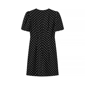 Detail view of the back of a black polka dot dress featuring hidden zipper and waist darts