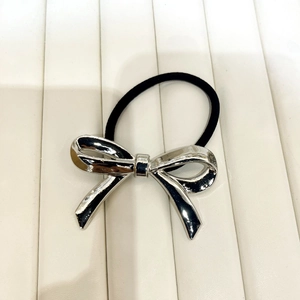 Minimalist black elastic hair tie with a shiny silver metallic bow pendant decoration