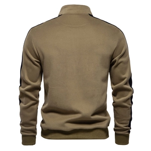 Detail view of khaki sports jacket back featuring black side stripes and ribbed cuffs