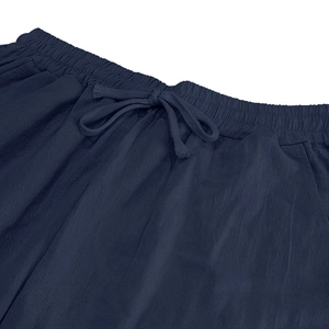 Detail of the dark blue linen trouser waist with elastic band and adjustable drawstring