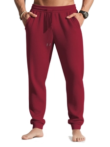Close-up of wine red waffle knit texture on men's athletic joggers with drawstring waist