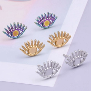 Detailed view of gold silver and colorful circular stainless steel stud earrings