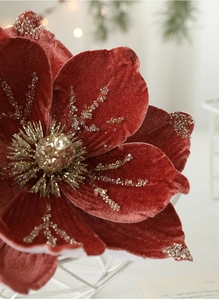 Macro shot of 24cm red velvet Christmas magnolia flower with gold sequins and beads