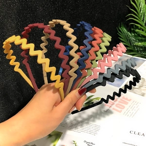 Set of 9 colorful wavy plastic headbands for women in various bright candy colors