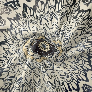 Detailed macro view of woven mandala textile with fine texture and soft bohemian drape