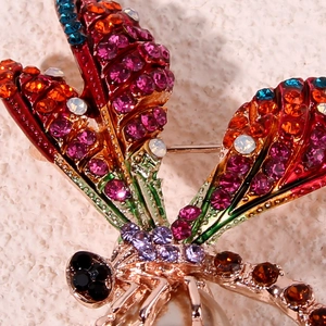 Luxury dragonfly brooch with colorful rhinestones and a large pearl on golden metal base