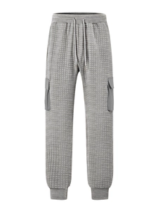 Detail of grey men's cargo joggers showing waffle knit texture and drawstring waist