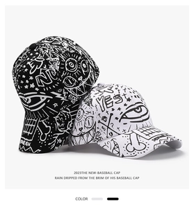 Detailed view of white and black graffiti baseball caps with trendy hand-drawn patterns