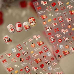 Detail of red New Year nail stickers featuring cartoon pony, apple and fireworks