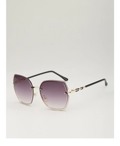 Detail of purple gradient lenses and gold metal temples on rimless oversized sunglasses