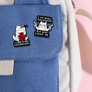 Funny cartoon cat enamel pins set featuring a white cat with d20 dice and a pistol