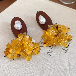 Detail view of irregular resin beads and wood texture on vintage ethnic style earrings