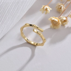 Minimalist bamboo style open ring in gold finish with textured adjustable band