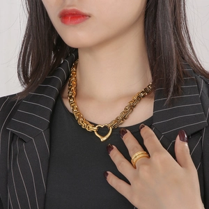 Detail of gold Byzantine chain necklace with heart clasp and matching ring set