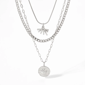 Detailed close-up of triple-layered silver stainless steel necklace with sunburst pendant