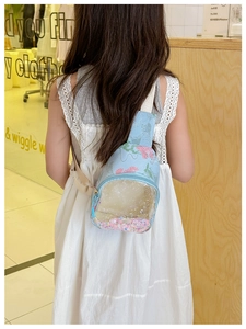 Child cross-body bag featuring blue canvas, floral print, and transparent glitter pocket