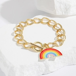 Detailed shot of golden chain bracelet with rainbow enamel pendant and OT clasp