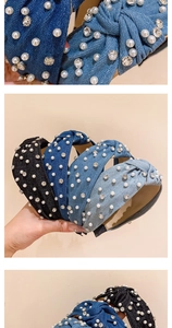 Detail of knotted denim headbands with sparkling rhinestones and white pearls in various blue shades
