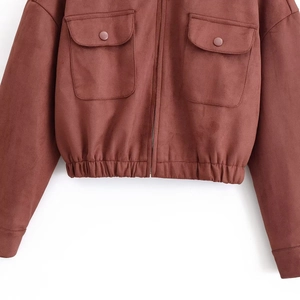 Detail of tan suede jacket featuring front utility pockets and elasticized hem design