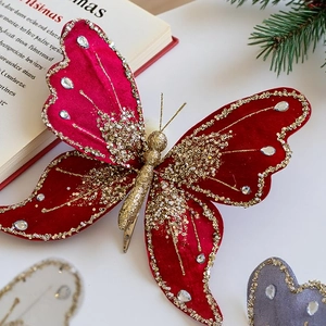Macro shot of red velvet butterfly clip with gold sequins and rhinestones decor