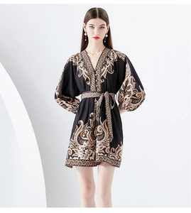 Close-up of V-neck and golden paisley print on this vintage mini puff sleeve dress