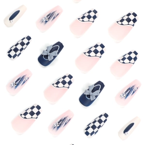 Blue checkerboard press-on nails with 3D bows and pearls on a clean white background