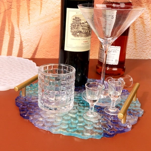 Blue gradient honeycomb resin tray with gold handles in a lifestyle setting