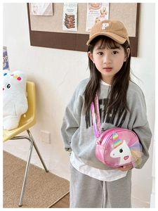 Pink unicorn crossbody bag for girls with rainbow horn and iridescent strap on model