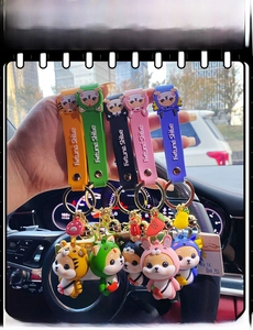 Hand holding set of five cute Shiba Inu keychains in various colorful animal costumes