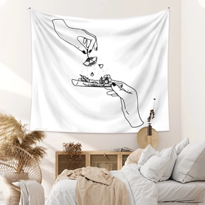 Close-up of minimalist line art tapestry featuring floral hand sketch in a cozy bedroom