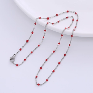 Detail of silver satellite chain necklace with red enamel beads and lobster clasp